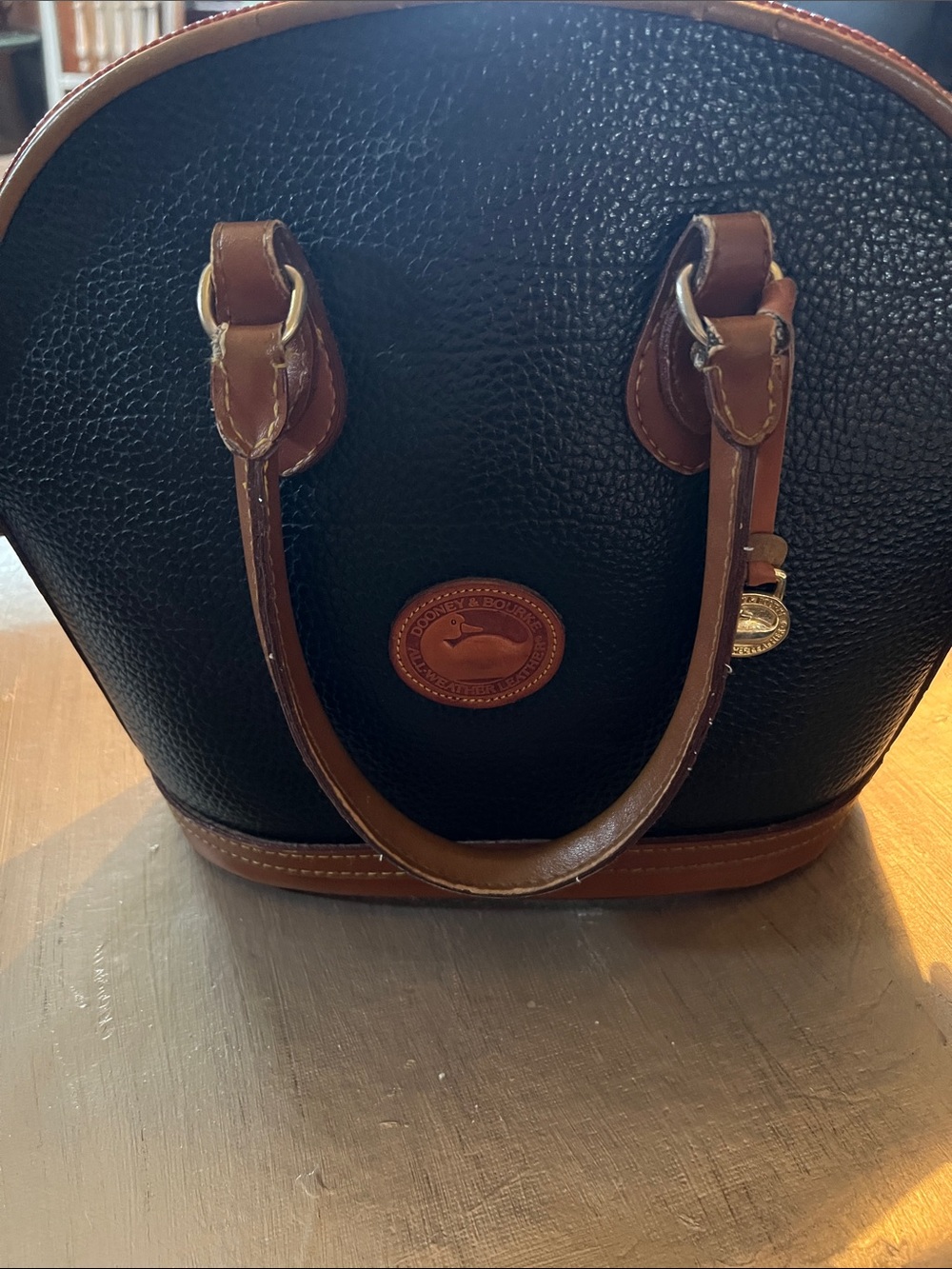 Dooney & Bourke Black Pebbled Leather Satchel with Brown Trim and Handles